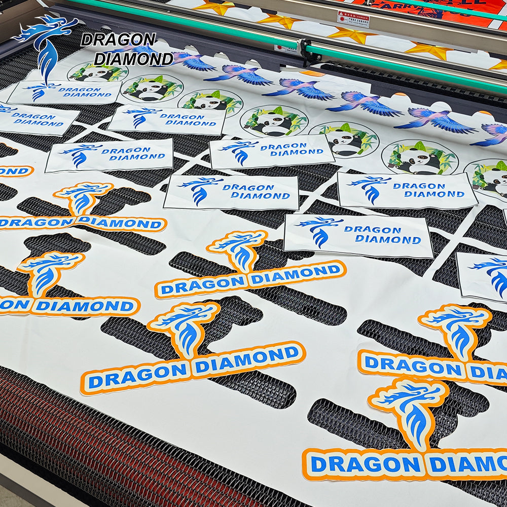 Printed fabric shapes cut around their artwork on a conveyor table