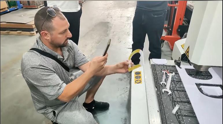 Israel customer inspecting Dragon Diamond CNC router during factory visit